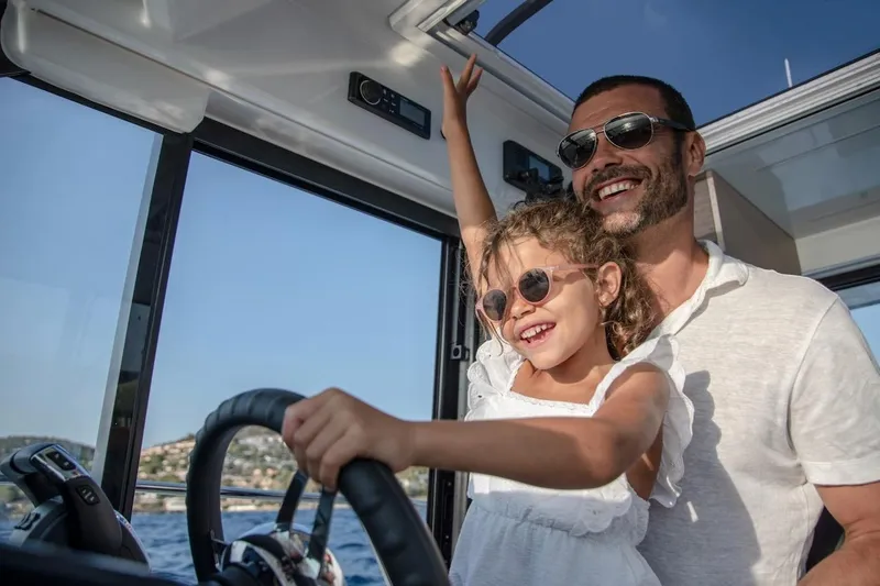 Slide: The Image of Father and daughter enjoying a ride on a 2025 Jeanneau NC 895 Series 2 boat. - 33