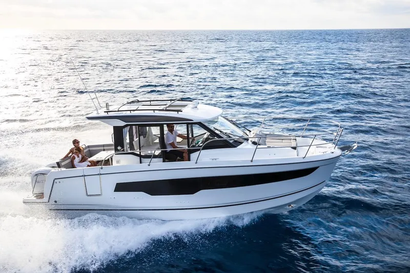 Slide: The Image of 2025 Jeanneau NC 895 Series 2 cruising on open sea with passengers onboard. - 40