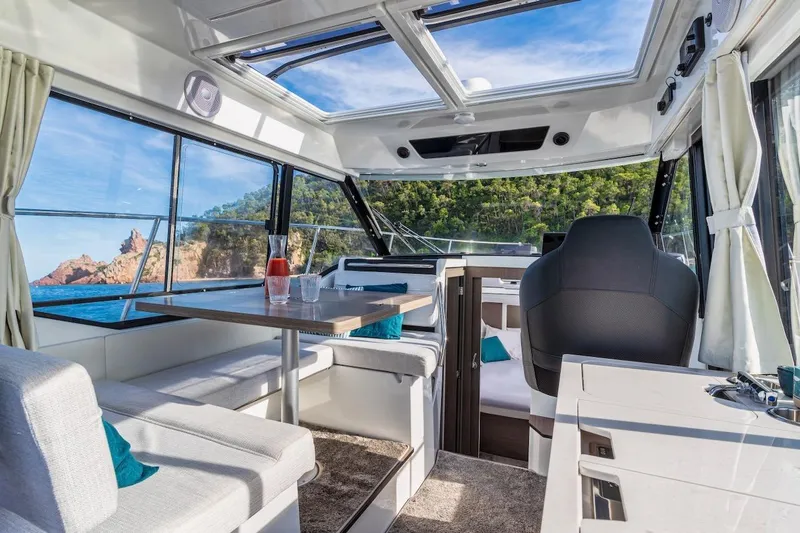 Slide: The Image of Interior of 2025 Jeanneau NC 895 Series 2 boat with panoramic windows and modern seating. - 46