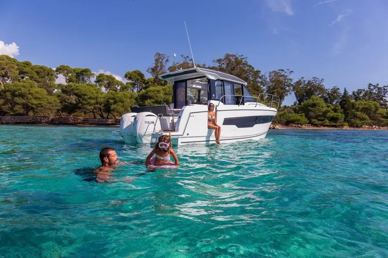Slide: The Image of Family enjoying water near 2025 Jeanneau NC 895 Series 2 boat in scenic bay. - 51