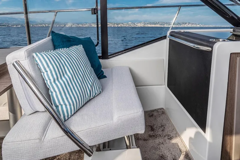 Slide: The Image of Interior of 2025 Jeanneau NC 895 Series 2 boat with cushioned seating and ocean view. - 59