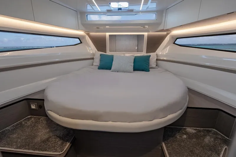 Slide: The Image of Luxurious cabin interior of 2025 Jeanneau NC 895 Series 2 with round bed and modern design. - 64