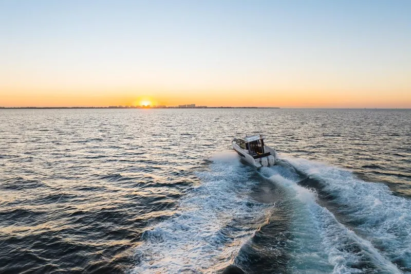 Slide: The Image of 2025 Jeanneau NC 895 Series 2 cruising at sunset on open water. - 66