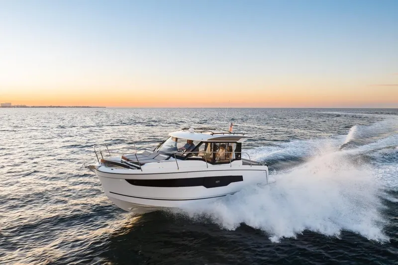 Slide: The Image of 2025 Jeanneau NC 895 Series 2 cruising at sunset on open water. - 67
