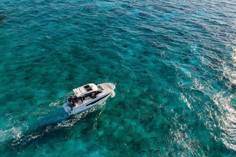 Slide: The Image of 2025 Jeanneau NC 895 Series 2 cruising on clear turquoise waters. - 70