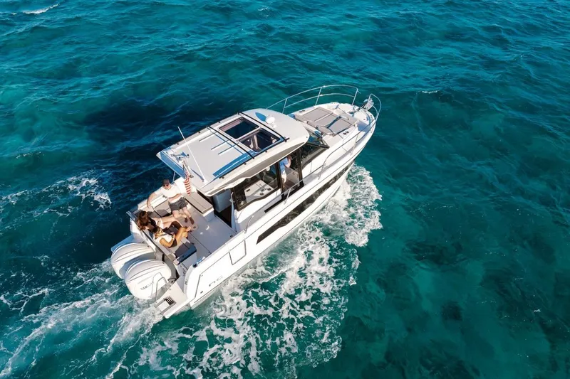 Slide: The Image of 2025 Jeanneau NC 895 Series 2 cruising on clear blue ocean waters. - 72