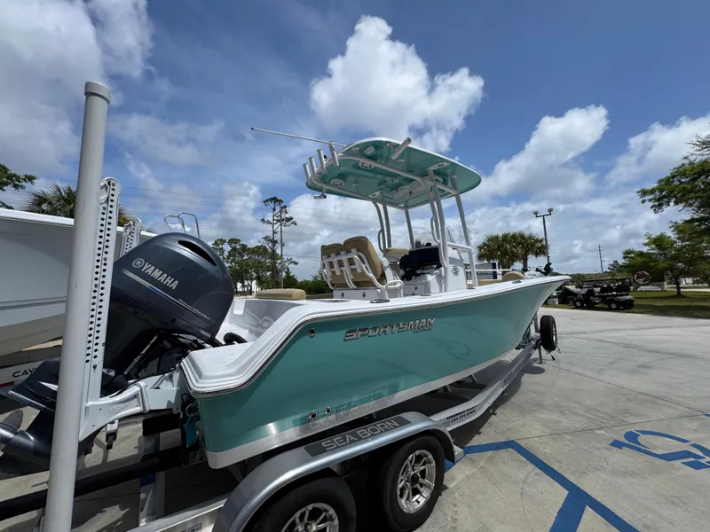 Slide: The Image of 2023 Sportsman Open 212 Center Console boat on trailer, parked outdoors under blue sky. - 13