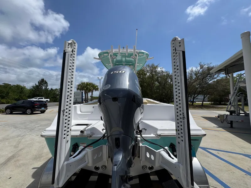 Slide: The Image of 2023 Sportsman Open 212 Center Console boat with powerful outboard motor, parked outdoors. - 16