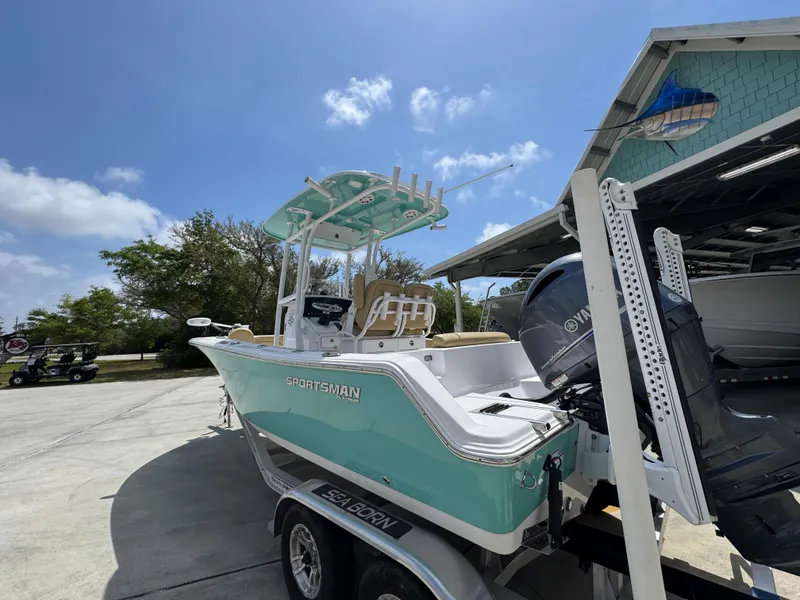 Slide: The Image of 2023 Sportsman Open 212 Center Console boat on trailer under clear sky. - 18