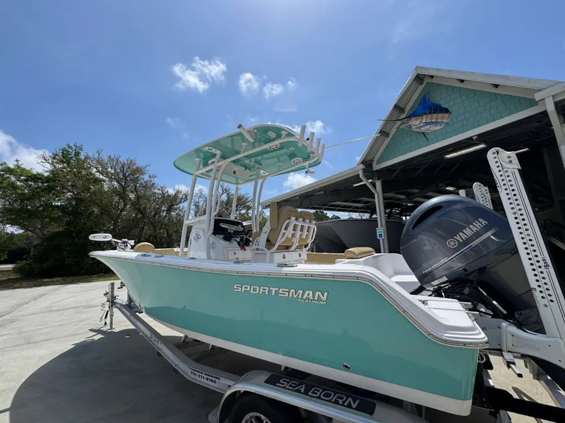 Slide: The Image of 2023 Sportsman Open 212 Center Console boat on trailer, parked outdoors under clear sky. - 19