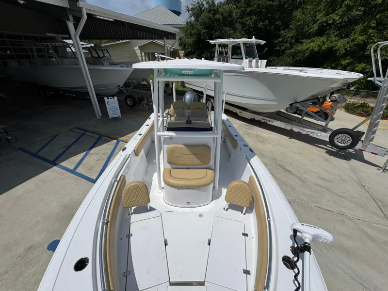 Slide: The Image of 2023 Sportsman Open 212 Center Console boat, docked, showcasing spacious seating and modern design. - 24