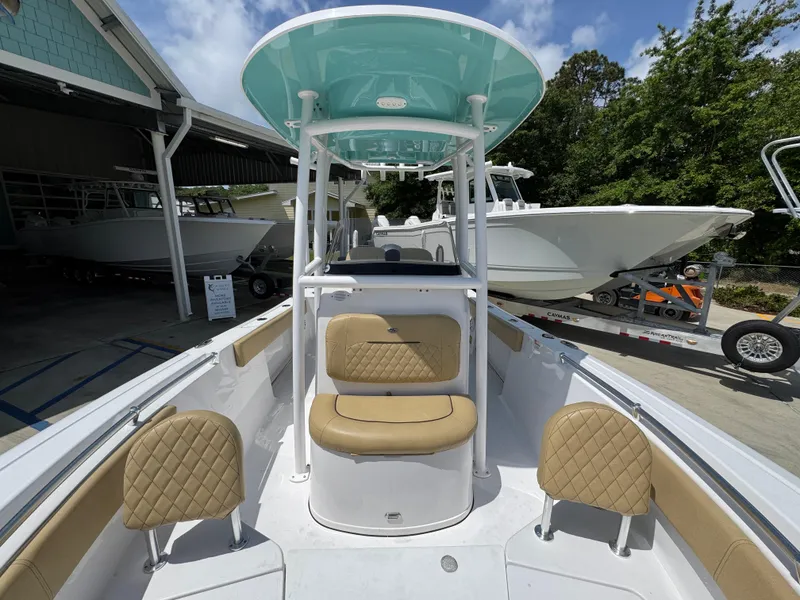 Slide: The Image of 2023 Sportsman Open 212 Center Console boat with tan seating and teal canopy. - 26