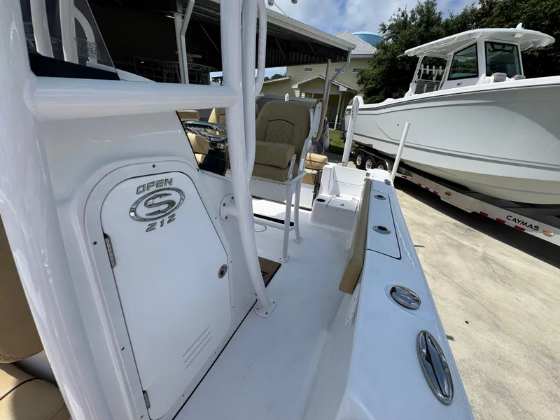 Slide: The Image of 2023 Sportsman Open 212 Center Console boat, white exterior, docked outdoors. - 28