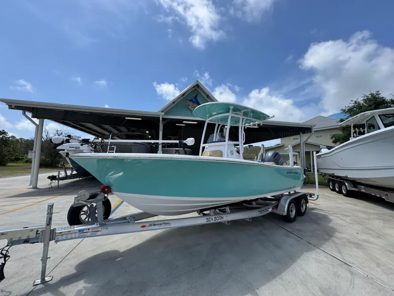 Slide: The Image of 2023 Sportsman Open 212 Center Console boat on trailer, parked outdoors under a blue sky. - 3