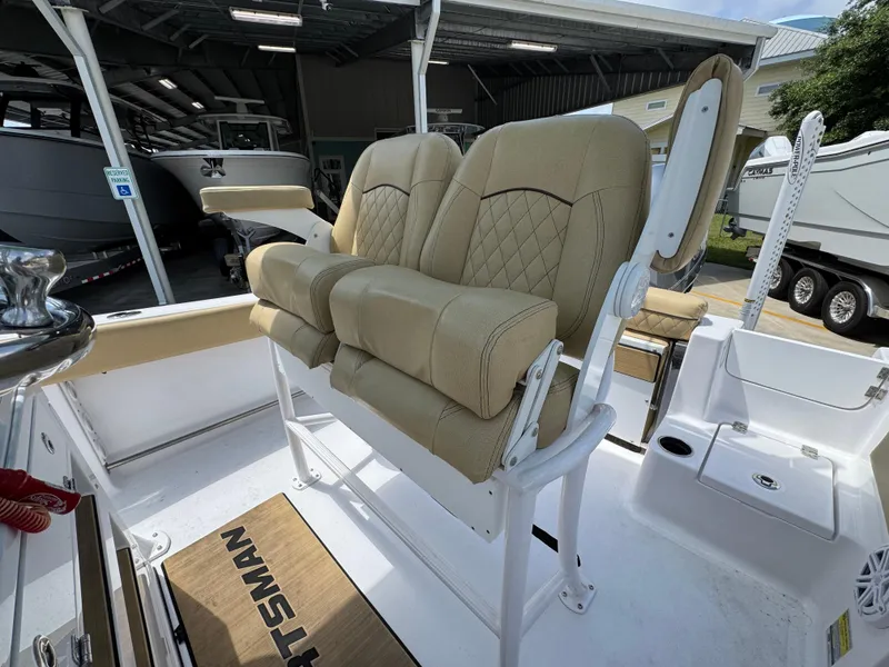 Slide: The Image of 2023 Sportsman Open 212 Center Console boat with beige cushioned seating. - 30