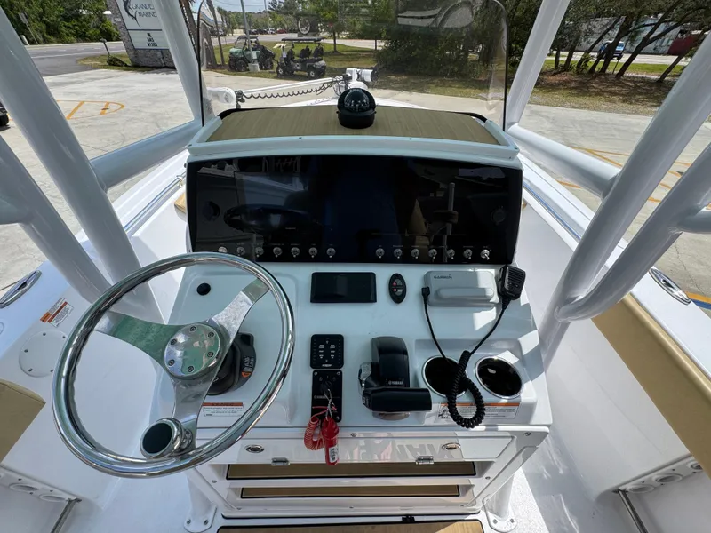 Slide: The Image of 2023 Sportsman Open 212 Center Console dashboard with steering wheel and navigation controls. - 33