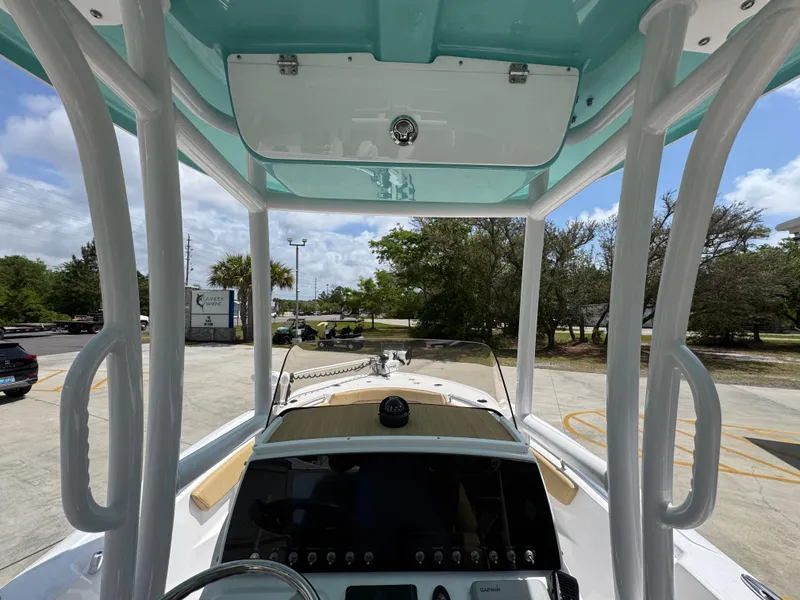 Slide: The Image of 2023 Sportsman Open 212 Center Console boat interior with console view and overhead storage. - 34