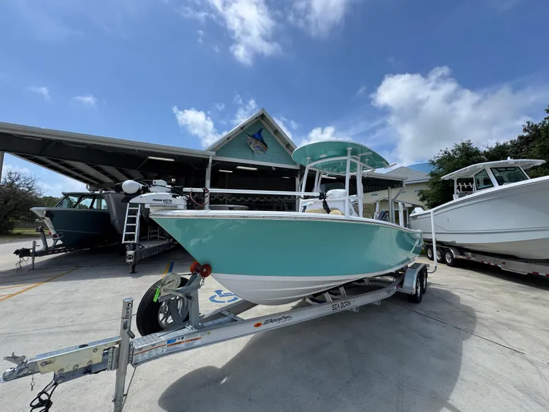 Slide: The Image of 2023 Sportsman Open 212 Center Console boat on trailer under blue sky. - 4