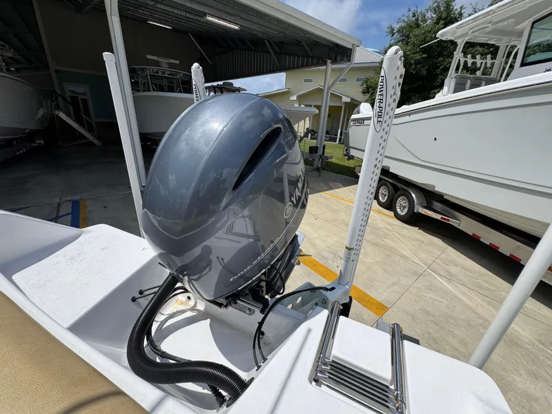 Slide: The Image of 2023 Sportsman Open 212 Center Console boat with outboard motor in a marina. - 41