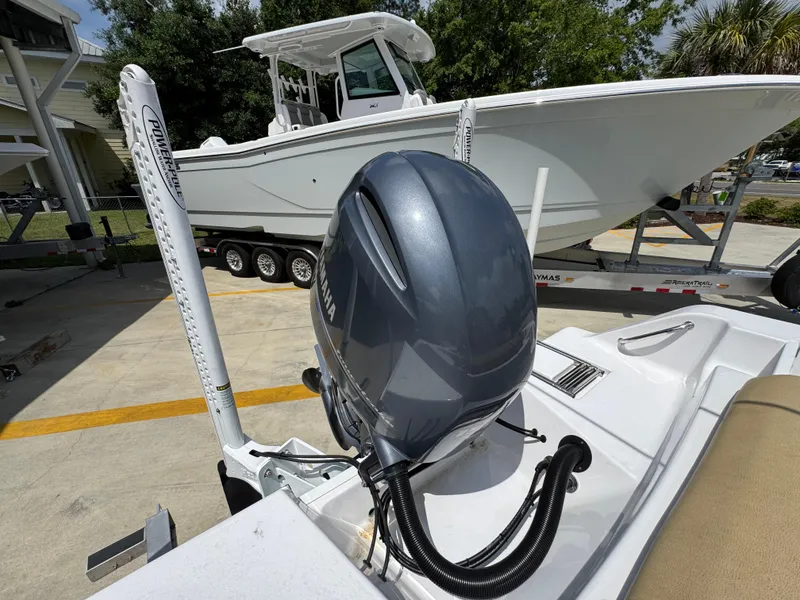 Slide: The Image of 2023 Sportsman Open 212 Center Console boat with powerful outboard motor, parked on trailer. - 42