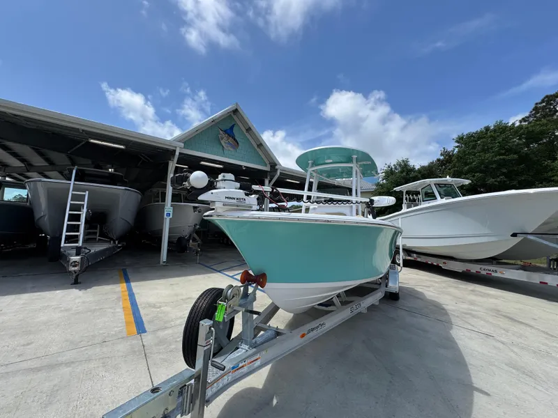 Slide: The Image of 2023 Sportsman Open 212 Center Console boat on trailer under blue sky. - 5