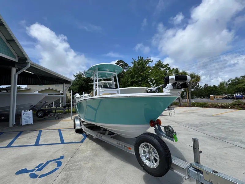 Slide: The Image of 2023 Sportsman Open 212 Center Console boat on trailer, parked outdoors. - 8
