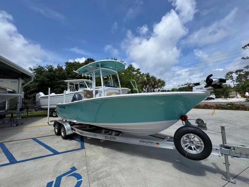 Slide: The Image of 2023 Sportsman Open 212 Center Console boat on trailer, parked outdoors. - 9