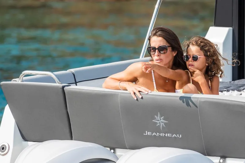 Slide: The Image of Woman and child relaxing on a 2025 Jeanneau NC 895 Series 2 boat. - 24