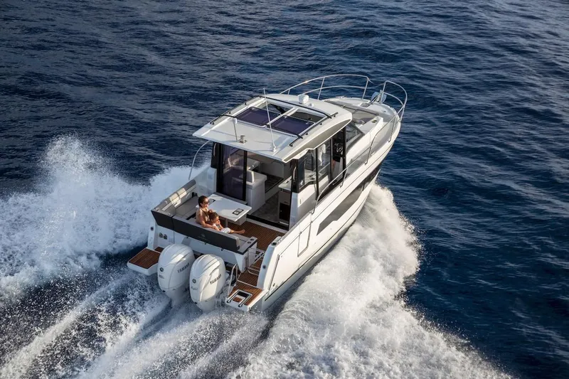 Slide: The Image of 2025 Jeanneau NC 895 Series 2 cruising on open water, showcasing sleek design and powerful engines. - 40