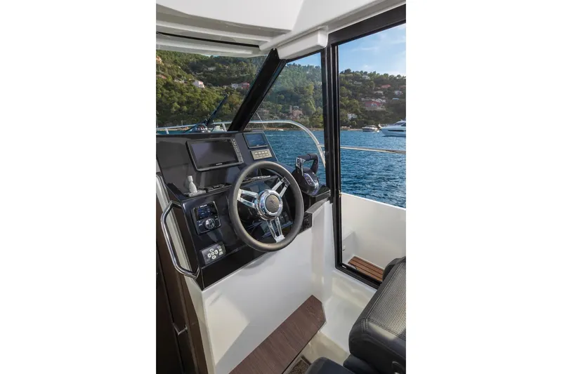 Slide: The Image of Helm of 2025 Jeanneau NC 895 Series 2 boat with scenic water view. - 61