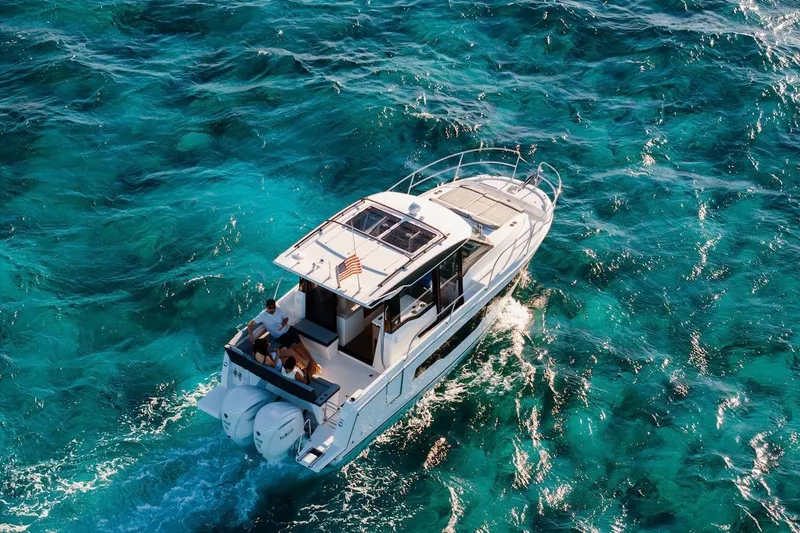 Slide: The Image of 2025 Jeanneau NC 895 Series 2 cruising on clear turquoise waters. - 72