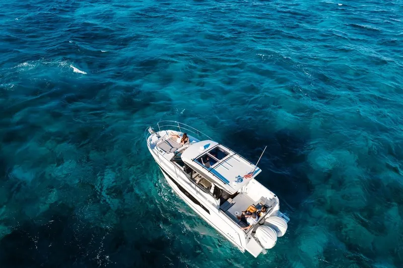 Slide: The Image of 2025 Jeanneau NC 895 Series 2 cruising on clear blue ocean waters. - 75