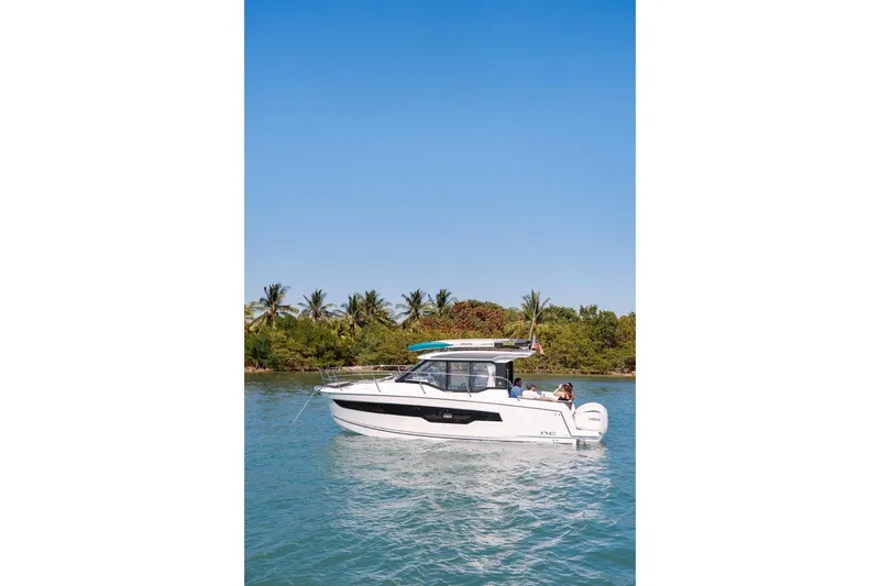 Slide: The Image of 2025 Jeanneau NC 895 Series 2 boat cruising on a tropical waterway. - 84