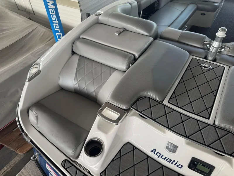Slide: The Image of 2015 MasterCraft X23 boat interior with gray seating and diamond stitching. - 13