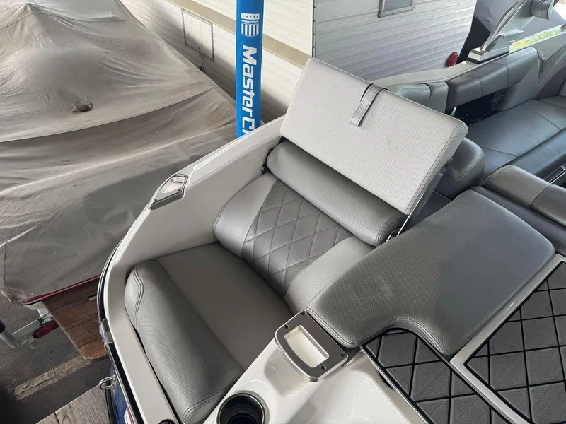Slide: The Image of 2015 MasterCraft X23 boat interior with gray seating and diamond stitching. - 15