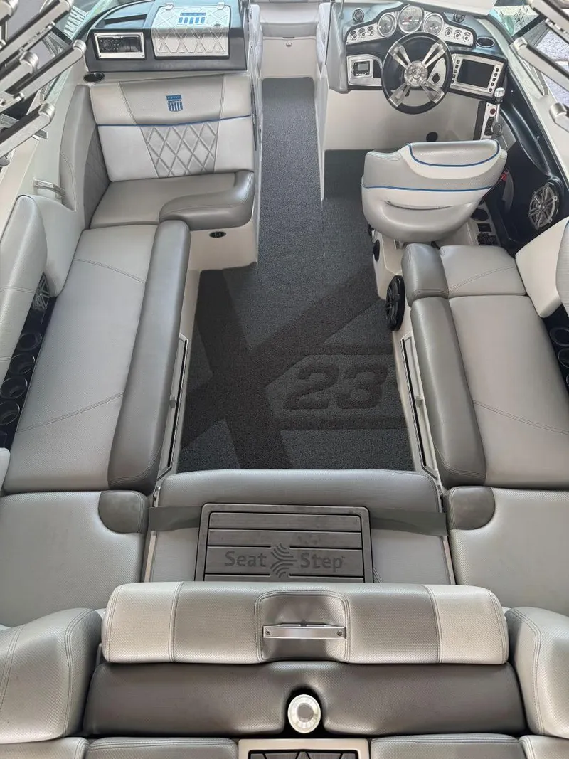 Slide: The Image of 2015 MasterCraft X23 boat interior with luxurious seating and modern dashboard. - 16