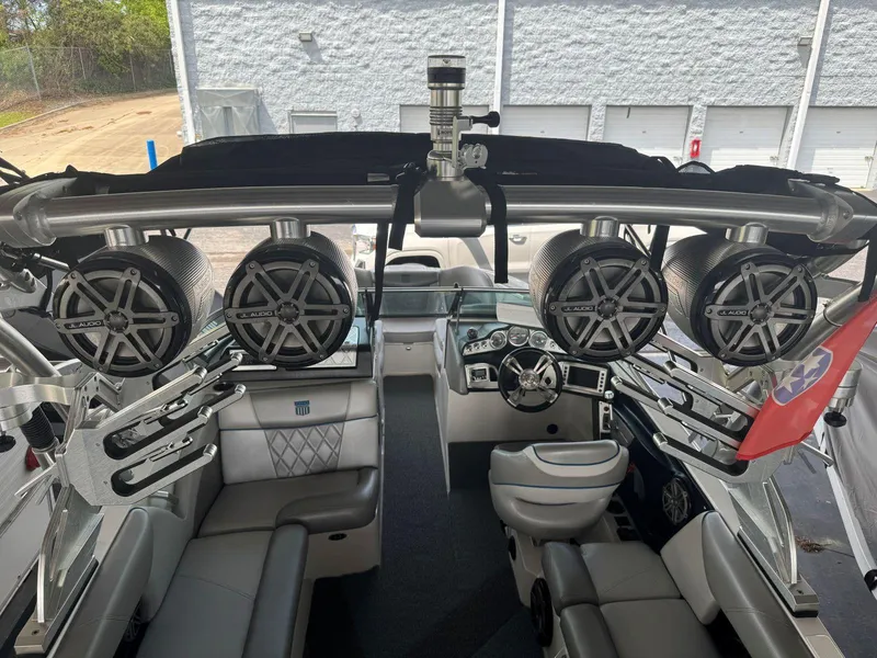 Slide: The Image of 2015 MasterCraft X23 boat interior with premium sound system and sleek seating. - 17