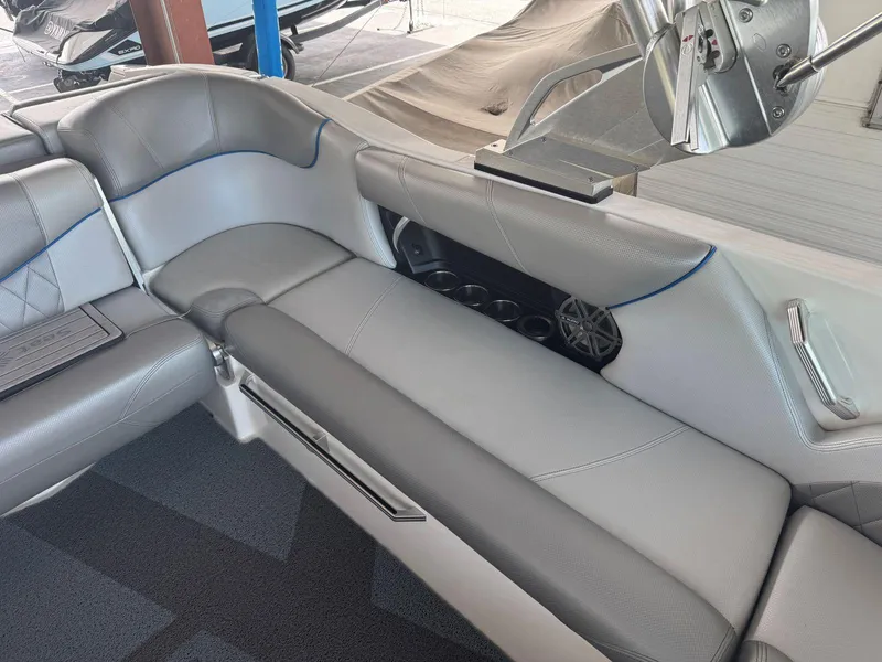 Slide: The Image of 2015 MasterCraft X23 boat interior with gray leather seating and cup holders. - 19