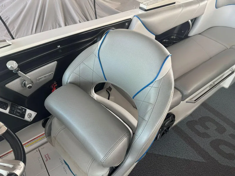 Slide: The Image of 2015 MasterCraft X23 boat interior with gray seating and blue accents. - 23