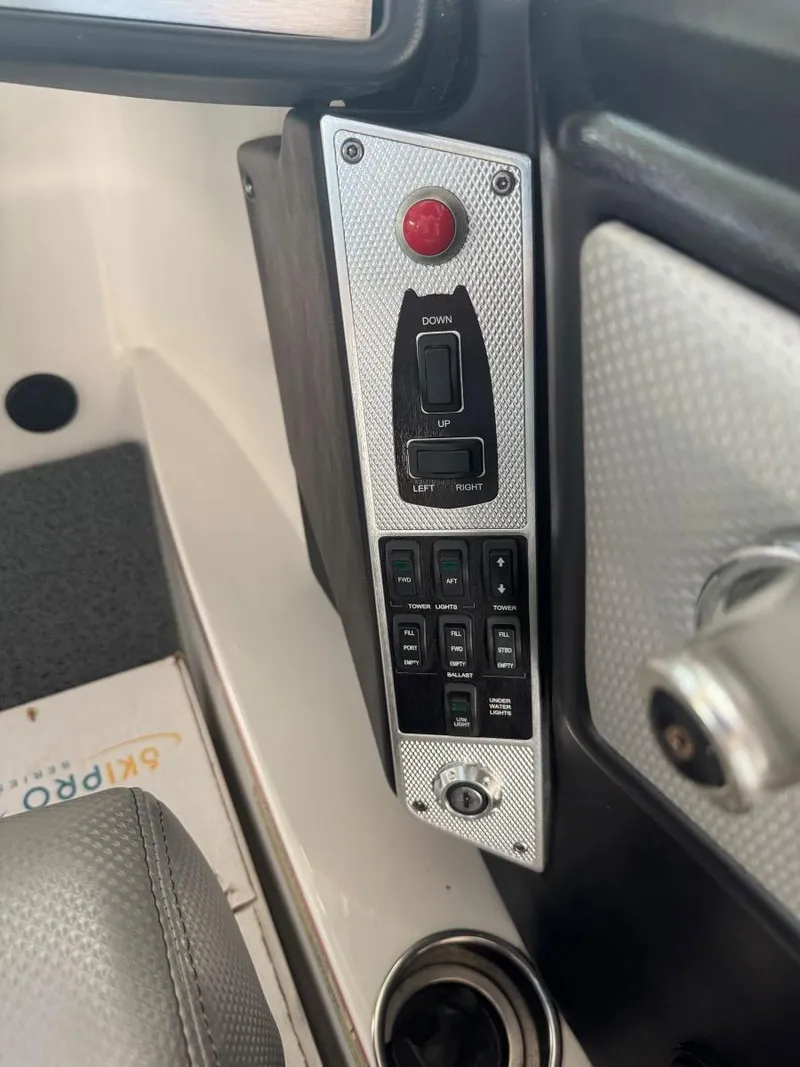 Slide: The Image of Control panel of a 2015 MasterCraft X23 boat with switches and buttons. - 25