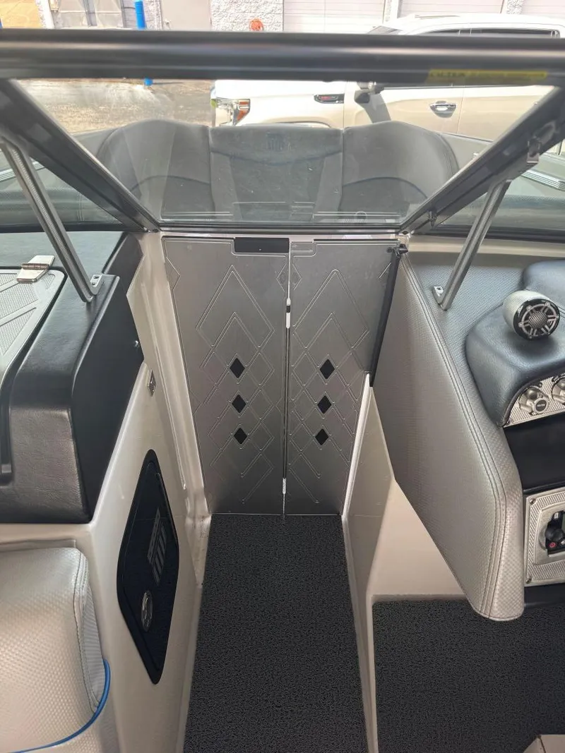 Slide: The Image of 2015 MasterCraft X23 boat interior with sleek design and modern dashboard features. - 28