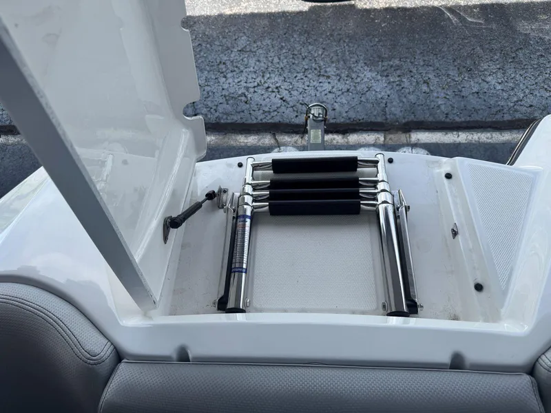 Slide: The Image of 2015 MasterCraft X23 boat ladder compartment with stainless steel retractable ladder. - 30