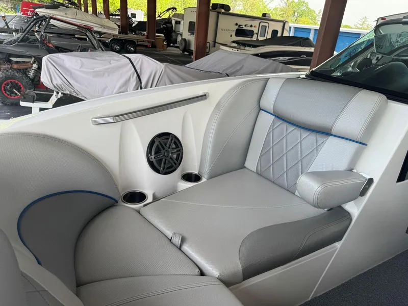 Slide: The Image of 2015 MasterCraft X23 boat interior with gray seating and speaker system. - 31