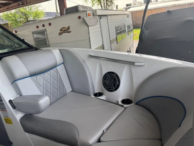 Slide: The Image of 2015 MasterCraft X23 boat interior with gray seating and speaker. - 32