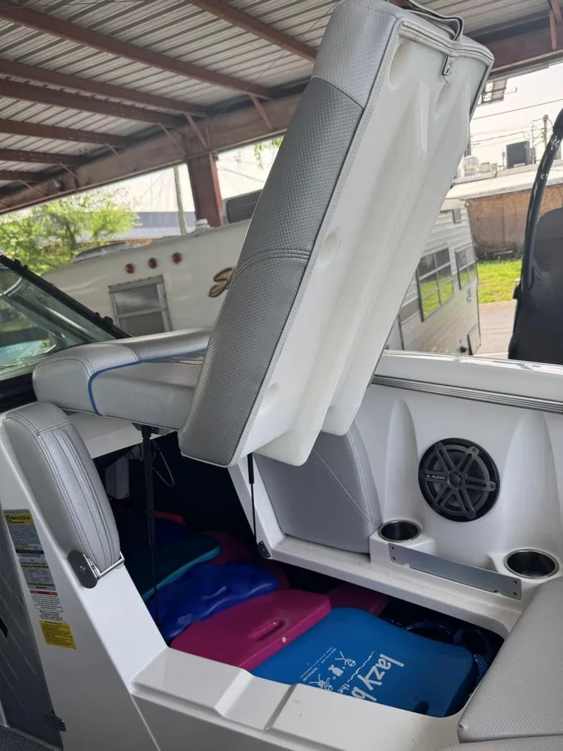 Slide: The Image of 2015 MasterCraft X23 boat interior with open storage compartment and speaker. - 35