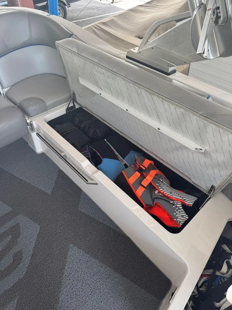 Slide: The Image of 2015 MasterCraft X23 boat storage compartment with life jackets and equipment. - 37