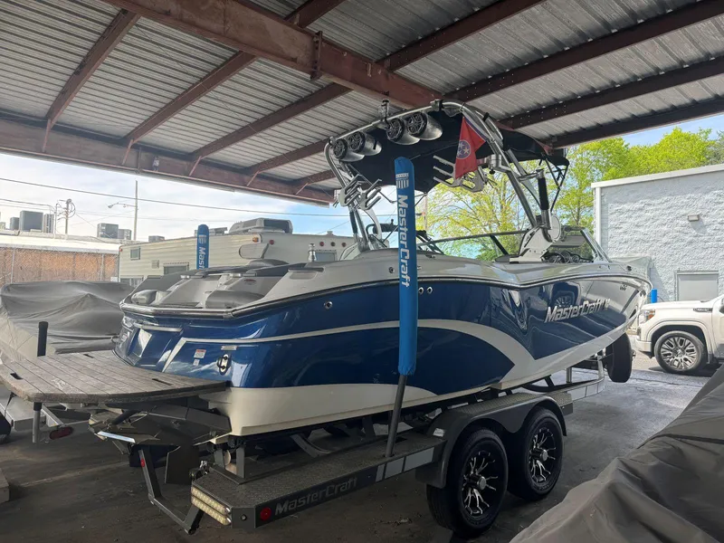 Slide: The Image of 2015 MasterCraft X23 boat on trailer in covered storage area. - 4
