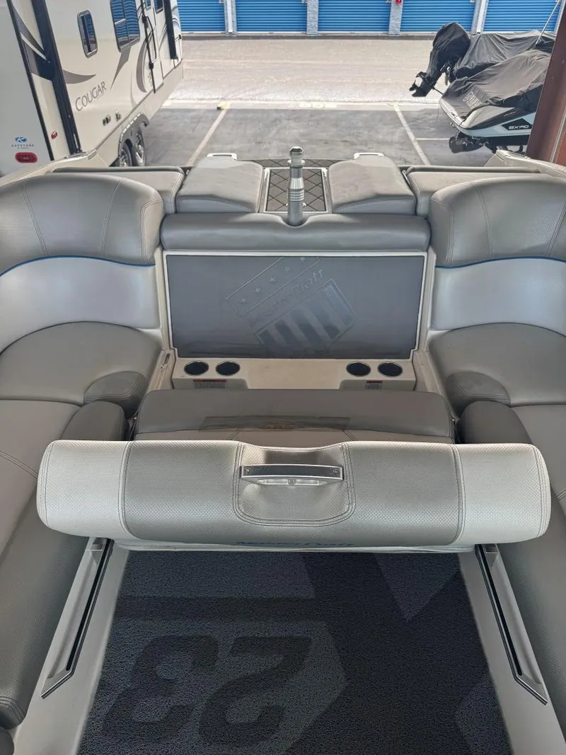 Slide: The Image of 2015 MasterCraft X23 boat interior with gray seating and cup holders. - 40
