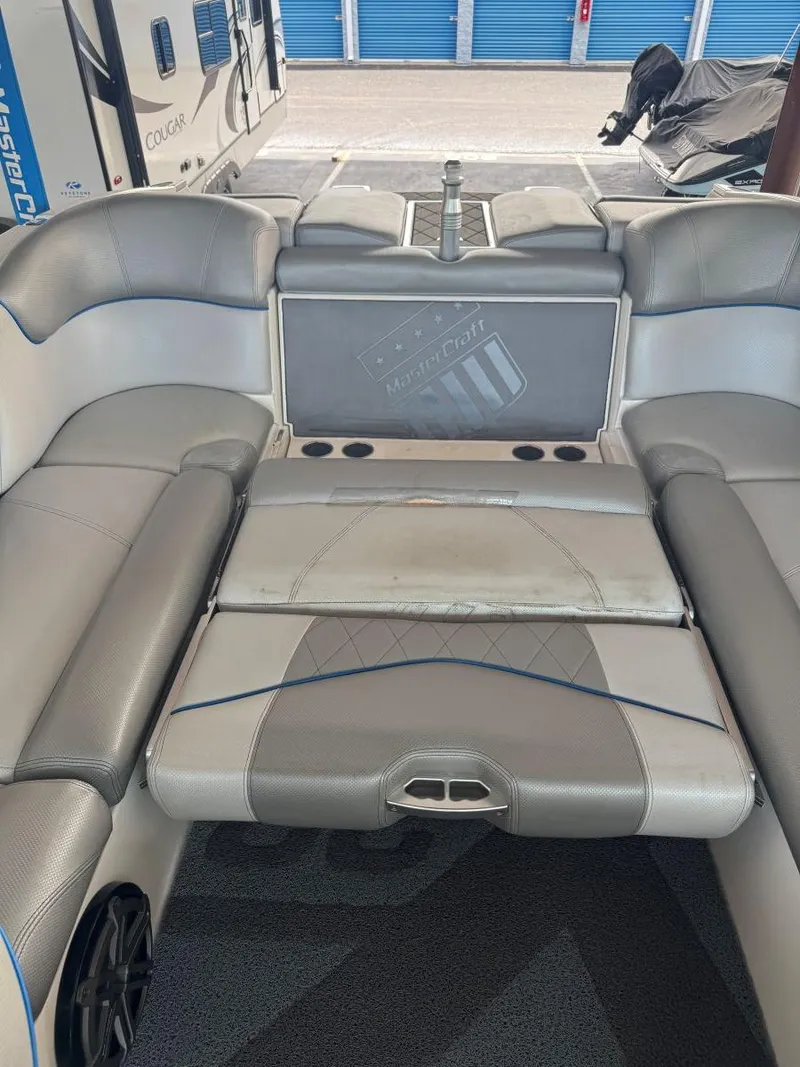 Slide: The Image of 2015 MasterCraft X23 boat interior with gray seating and cup holders. - 41