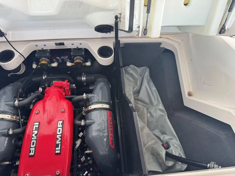 Slide: The Image of 2015 MasterCraft X23 engine compartment with Ilmor engine, showcasing red and gray components. - 44
